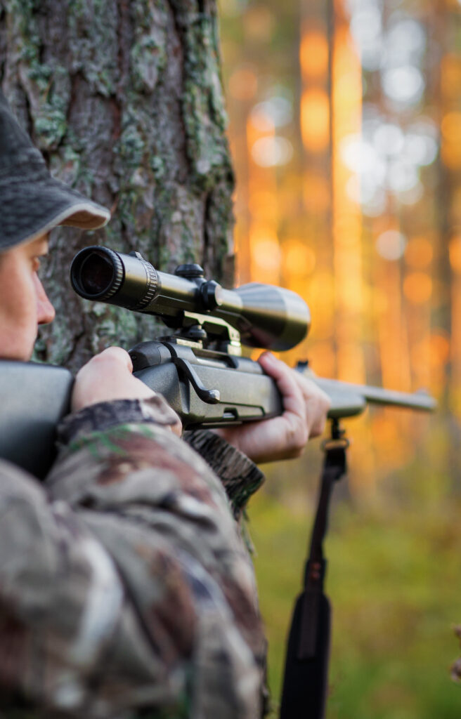 Hunter looking into rifle scope